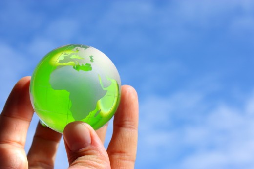 image of a hand holding a green globe
