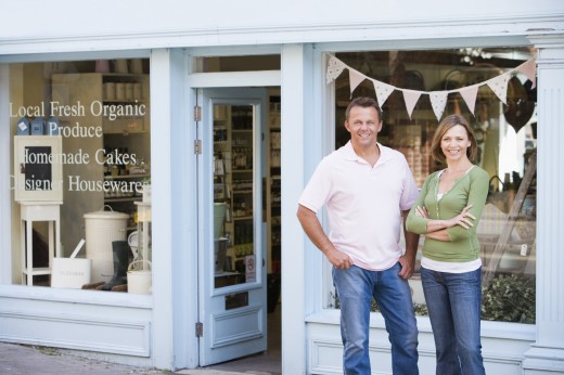 image of Couple standing in front of organic food store smiling